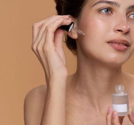 Women apply vitamin c serum